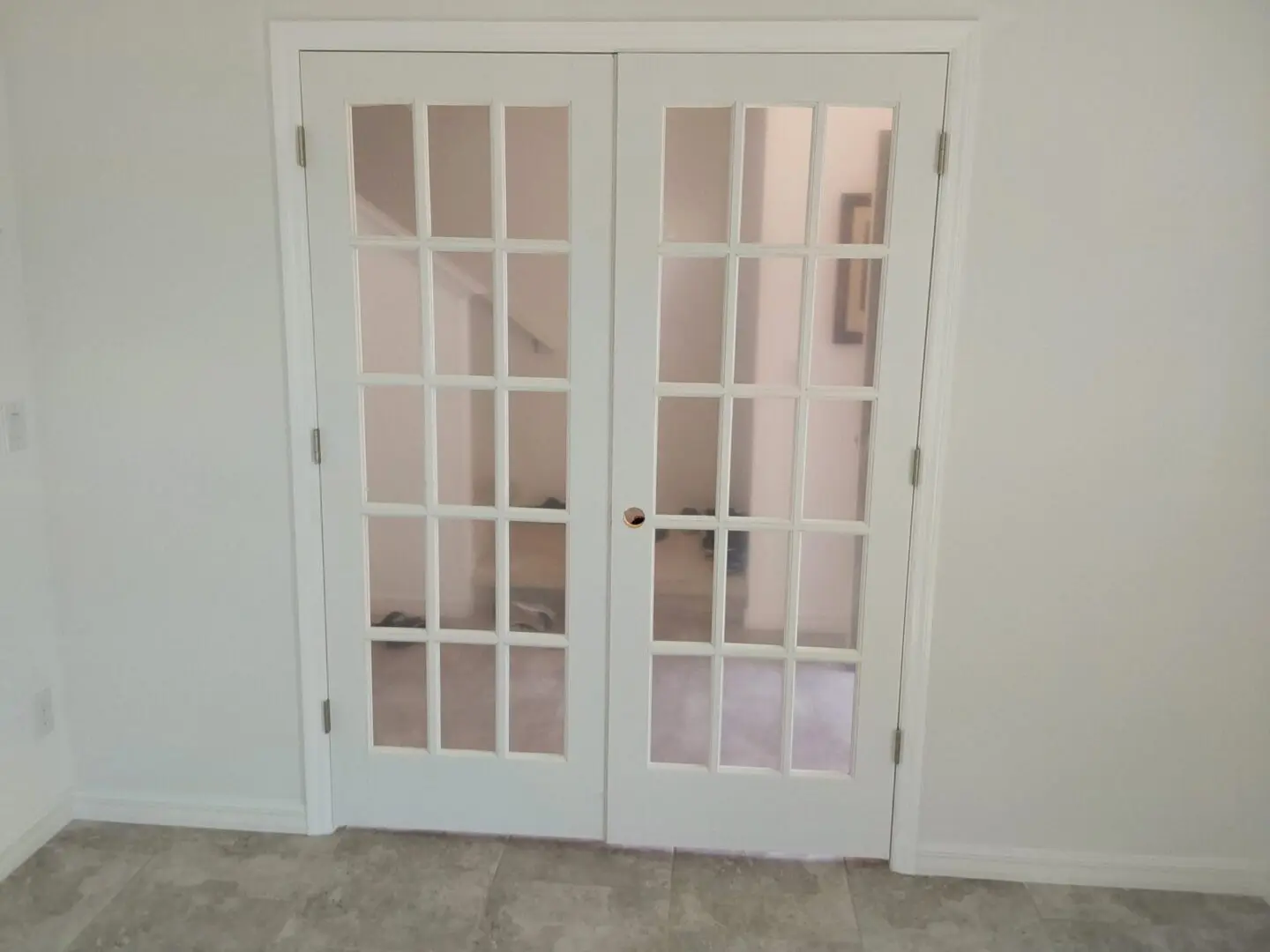 A pair of white doors with glass panes.